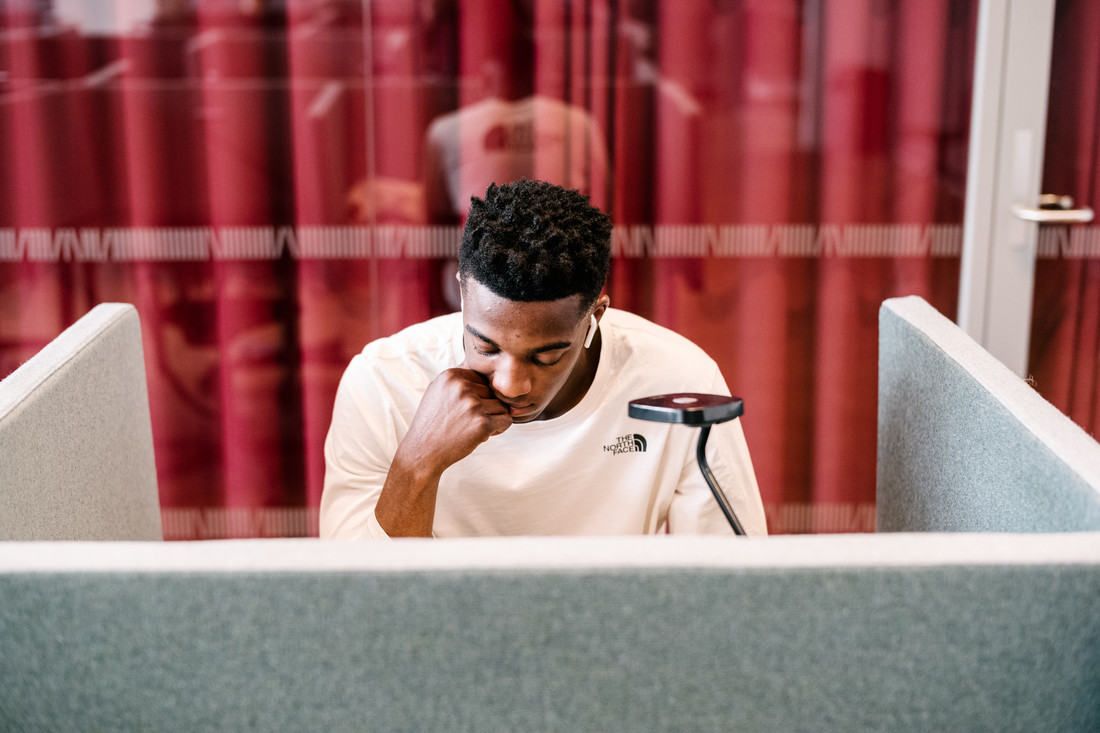 International student studying while looking at his computer